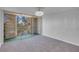 This bedroom features a sliding glass door and neutral carpeting at 725 N Royal Crest Cir # 246, Las Vegas, NV 89169