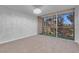 Sunlit bedroom with carpet, chandelier and sliding glass doors opening to balcony at 725 N Royal Crest Cir # 246, Las Vegas, NV 89169