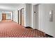 Hallway leading to units featuring elevator and patterned flooring at 725 N Royal Crest Cir # 246, Las Vegas, NV 89169