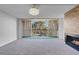 This open living room features a fireplace and sliding glass doors leading to the balcony at 725 N Royal Crest Cir # 246, Las Vegas, NV 89169