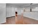 Inviting living space featuring sleek hardwood floors, closet doors, and partial kitchen view at 725 N Royal Crest Cir # 246, Las Vegas, NV 89169