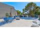 This community patio has multiple chairs, tables, and umbrellas for outdoor enjoyment at 725 N Royal Crest Cir # 246, Las Vegas, NV 89169