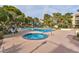 Community pool and hot tub with lounge chairs and mature trees create a welcoming outdoor space at 725 N Royal Crest Cir # 246, Las Vegas, NV 89169