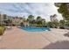 Relaxing community pool with lounge chairs and mature trees in a well-maintained residential area at 725 N Royal Crest Cir # 246, Las Vegas, NV 89169
