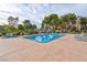 Outdoor community pool and hot tub with mature trees and lounge chairs for relaxing by the water at 725 N Royal Crest Cir # 246, Las Vegas, NV 89169