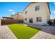 This private backyard is complete with artificial turf and a paver patio at 7714 Duran Harbor Ln, North Las Vegas, NV 89084