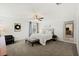 Bright bedroom with neutral tones, featuring a queen bed at 7714 Duran Harbor Ln, North Las Vegas, NV 89084