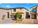 Inviting two-story home with a brown roof, a two car garage, and simple landscaping at 7714 Duran Harbor Ln, North Las Vegas, NV 89084