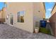 Home exterior featuring a view of the backyard pavers, adjacent building, and access gate at 7714 Duran Harbor Ln, North Las Vegas, NV 89084
