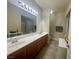 A bathroom is equipped with double sinks, tiled floors and vanity mirror at 833 Aspen Peak Loop # 1021, Henderson, NV 89011