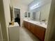 Double sink bathroom vanity with overhead lighting and beige colored walls at 833 Aspen Peak Loop # 1021, Henderson, NV 89011