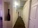 A neutral hallway features an alcove, dark wood floors and lots of doors at 833 Aspen Peak Loop # 1021, Henderson, NV 89011
