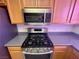 Gas range and stainless steel microwave in a well-maintained kitchen at 833 Aspen Peak Loop # 1021, Henderson, NV 89011