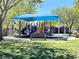 Gathering friendly playground with slides, climbing structures, benches and a shaded area at 833 Aspen Peak Loop # 1021, Henderson, NV 89011