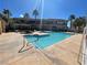 Outdoor pool area featuring ample space, lounge seating, palm trees, and shade structures at 833 Aspen Peak Loop # 1021, Henderson, NV 89011