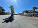 Street view of community featuring palm trees and well-maintained condominium buildings at 833 Aspen Peak Loop # 1021, Henderson, NV 89011