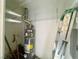 Utility closet with a hot water heater, wire shelving, and ladder at 833 Aspen Peak Loop # 1021, Henderson, NV 89011