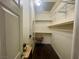 A nice walk-in closet with a colorful chair and mirror, with shelving at 833 Aspen Peak Loop # 1021, Henderson, NV 89011