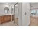 Bathroom featuring double sinks, wood cabinets, and a mirrored closet at 8537 Glenmount Dr, Las Vegas, NV 89134