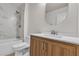 Bathroom featuring a shower-tub combination with new tile, a new toilet, and wood cabinets at 8537 Glenmount Dr, Las Vegas, NV 89134