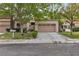 Charming home featuring a spacious two-car garage and a well-maintained lawn with mature trees at 8537 Glenmount Dr, Las Vegas, NV 89134
