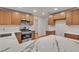 Well-equipped kitchen boasts stainless steel appliances, quartz countertops, and ample lighting for gourmet cooking at 8537 Glenmount Dr, Las Vegas, NV 89134