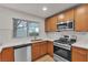 Well-lit kitchen featuring stainless steel appliances, wood cabinets, and a window with a view at 8537 Glenmount Dr, Las Vegas, NV 89134