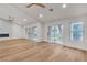 Spacious living room featuring light hardwood floors, sliding glass doors, and ample natural light at 8537 Glenmount Dr, Las Vegas, NV 89134