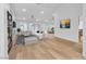 Open-concept living room with fireplace, modern seating, and seamless flow to the dining area and kitchen at 8537 Glenmount Dr, Las Vegas, NV 89134