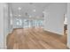 Open-concept living area featuring light wood floors, a modern fireplace, and natural light at 8537 Glenmount Dr, Las Vegas, NV 89134