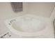 Close up of the bathroom's soaking tub, surrounded by matching tile work at 8543 Alpine Vineyards Ct, Las Vegas, NV 89139