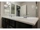 Stylish bathroom featuring a double sink vanity with dark cabinets and a bright countertop at 8543 Alpine Vineyards Ct, Las Vegas, NV 89139