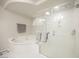 Bright bathroom features a soaking tub and a glass-enclosed shower at 8543 Alpine Vineyards Ct, Las Vegas, NV 89139