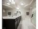 Bright bathroom featuring double sinks, a glass enclosed shower, and a soaking tub at 8543 Alpine Vineyards Ct, Las Vegas, NV 89139