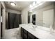 Bathroom featuring a double vanity with sleek countertops, updated fixtures, and a shower/tub combo at 8543 Alpine Vineyards Ct, Las Vegas, NV 89139