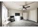 Bright bedroom with a ceiling fan, soft carpet, and a large window for natural light at 8543 Alpine Vineyards Ct, Las Vegas, NV 89139