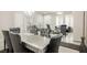 Elegant dining room featuring a glass-top table with six velvet chairs and modern chandelier at 8543 Alpine Vineyards Ct, Las Vegas, NV 89139