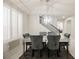 Dining room with modern lighting, six velvet chairs, and shuttered windows for natural light at 8543 Alpine Vineyards Ct, Las Vegas, NV 89139