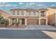 Charming two-story house featuring front yard landscaping, a three-car garage, and a cozy second-floor covered patio at 8543 Alpine Vineyards Ct, Las Vegas, NV 89139