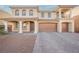 Stunning two-story home with a three-car garage, columns, and elegant front yard landscaping at 8543 Alpine Vineyards Ct, Las Vegas, NV 89139