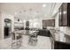 Contemporary kitchen featuring granite countertops, pendant lighting, and marble flooring at 8543 Alpine Vineyards Ct, Las Vegas, NV 89139