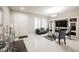 Bright living room with white marble floors, a decorative fireplace, and plantation shutters at 8543 Alpine Vineyards Ct, Las Vegas, NV 89139