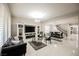 Open-concept living room featuring marble floors, modern lighting and a decorative fireplace at 8543 Alpine Vineyards Ct, Las Vegas, NV 89139