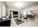 Open-concept living room featuring marble floors, modern lighting and a decorative fireplace at 8543 Alpine Vineyards Ct, Las Vegas, NV 89139