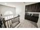 Open staircase leads to the upper level, showcasing dark wood cabinets and unique architectural details at 8543 Alpine Vineyards Ct, Las Vegas, NV 89139