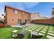 Large backyard featuring a patio, outdoor seating, artificial grass and a barbecue grill at 8636 Caribbean Ct, Las Vegas, NV 89117
