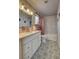 Bright bathroom featuring a vanity with stone counter, subway tiles, and patterned floor at 8636 Caribbean Ct, Las Vegas, NV 89117