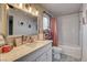 Bright bathroom featuring a vanity with stone counter, subway tiles, and patterned floor at 8636 Caribbean Ct, Las Vegas, NV 89117