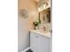 Chic powder bathroom with white vanity, modern light fixture, and decorative silver starburst at 8636 Caribbean Ct, Las Vegas, NV 89117