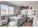 Cozy bedroom featuring modern decor, a well-lit vanity, and ample natural light at 8636 Caribbean Ct, Las Vegas, NV 89117